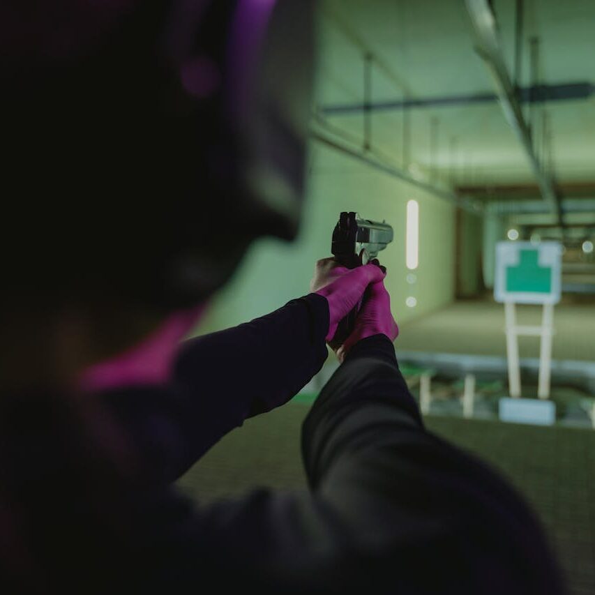 Firearm training at Big Iron Handgun License Course in Waco, indoor shooting simulation.